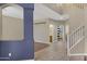 Tile entryway leading to the living room with a view of a bathroom and staircase at 10758 E Lobo Ave, Mesa, AZ 85209