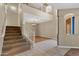 Dramatic entryway with soaring ceilings, staircase, and a view into the adjacent living spaces at 10758 E Lobo Ave, Mesa, AZ 85209