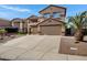 Spacious home with a long driveway leading to a three-car garage and desert landscaping at 10758 E Lobo Ave, Mesa, AZ 85209