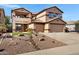 Attractive two-story home boasting a well-manicured front yard, stone accents, and a three-car garage at 10758 E Lobo Ave, Mesa, AZ 85209