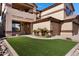 Charming home featuring a manicured front yard with artificial turf and a covered entryway at 10758 E Lobo Ave, Mesa, AZ 85209