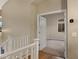 Hallway overlooking a bedroom with wood floors and fresh paint leading to a bedroom with carpet at 10758 E Lobo Ave, Mesa, AZ 85209