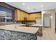 Well lit kitchen with light colored cabinets, counters and floor tiles and stainless steel appliances at 10758 E Lobo Ave, Mesa, AZ 85209