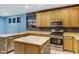 Spacious kitchen with stainless steel appliances, brick-style base and light colored cabinets and counters at 10758 E Lobo Ave, Mesa, AZ 85209