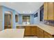 Spacious kitchen area overlooking the backyard pool with light colored cabinets and counters at 10758 E Lobo Ave, Mesa, AZ 85209