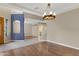 Bright and airy living room with a chandelier and view of the entry at 10758 E Lobo Ave, Mesa, AZ 85209