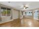 Spacious living room with wood floors, large windows, and neutral paint colors, offering abundant natural light at 10758 E Lobo Ave, Mesa, AZ 85209