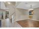 Open concept living room featuring soaring ceilings, tile floors, and an adjacent staircase at 10758 E Lobo Ave, Mesa, AZ 85209