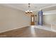 Spacious living room with wood floors and a decorative chandelier at 10758 E Lobo Ave, Mesa, AZ 85209