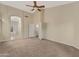 Spacious main bedroom with carpet, neutral walls, and a large door to the main bathroom and closet at 10758 E Lobo Ave, Mesa, AZ 85209