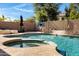 Resort-style backyard pool with a hot tub, landscaping, and desert plants in a private setting at 10758 E Lobo Ave, Mesa, AZ 85209