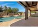 Resort-style backyard pool with a hot tub, patio, and desert plants in a private setting at 10758 E Lobo Ave, Mesa, AZ 85209