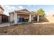 Home's backyard featuring a covered patio, desert landscaping, and block wall at 11221 W Devonshire Ave, Phoenix, AZ 85037