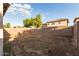 Home's backyard featuring desert landscaping surrounded by a block wall for privacy at 11221 W Devonshire Ave, Phoenix, AZ 85037