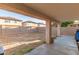 View of the home's backyard featuring a covered patio, desert landscaping, and block wall at 11221 W Devonshire Ave, Phoenix, AZ 85037