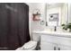 Bathroom featuring a vanity, toilet, and shower with dark shower curtain at 11221 W Devonshire Ave, Phoenix, AZ 85037