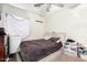 Bedroom with a window and carpet flooring, featuring a full-size bed at 11221 W Devonshire Ave, Phoenix, AZ 85037