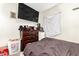 Bedroom with carpet and a window with a large television mounted to the wall at 11221 W Devonshire Ave, Phoenix, AZ 85037