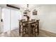 Cozy dining area features wood-look tile flooring and natural light near the outdoor patio at 11221 W Devonshire Ave, Phoenix, AZ 85037