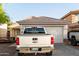 View of the home's front exterior, highlighting the garage and driveway at 11221 W Devonshire Ave, Phoenix, AZ 85037