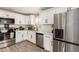Well-lit kitchen featuring stainless steel appliances, white cabinets, and a stylish faucet at 11221 W Devonshire Ave, Phoenix, AZ 85037
