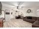 Spacious living room featuring tile floors and a comfortable sectional sofa at 11221 W Devonshire Ave, Phoenix, AZ 85037