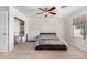 Cozy bedroom features carpeted floors, a ceiling fan, and a closet for convenient storage solutions at 11341 W Barbara Ave, Peoria, AZ 85345