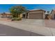 Attractive single-Gathering home featuring a two-car garage and desert-style front yard landscaping at 11341 W Barbara Ave, Peoria, AZ 85345