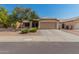 Charming single-story home with a well-kept front yard and a convenient two-car garage at 11341 W Barbara Ave, Peoria, AZ 85345