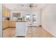 Inviting kitchen area with an island, backyard access, plenty of cabinets, and a ceiling fan at 11341 W Barbara Ave, Peoria, AZ 85345