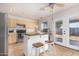 Efficient kitchen with a center island, stainless appliances, and bright natural light from the backyard doors at 11341 W Barbara Ave, Peoria, AZ 85345