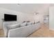 Bright living room boasts an expansive sectional sofa, stylish floors, and recessed lighting at 11341 W Barbara Ave, Peoria, AZ 85345
