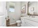 Bright bathroom featuring wood-style flooring, stylish decor, and a white vanity at 11526 E Shepperd Ave, Mesa, AZ 85212