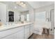 Bright bathroom with double sinks, white cabinetry, a soaking tub, and separate shower at 11526 E Shepperd Ave, Mesa, AZ 85212