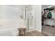 Well-lit bathroom featuring a bathtub, glass-enclosed shower, and access to the walk-in closet at 11526 E Shepperd Ave, Mesa, AZ 85212