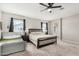 Large bedroom featuring a ceiling fan, neutral carpet, and multiple windows for natural light at 11526 E Shepperd Ave, Mesa, AZ 85212