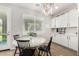 Bright dining area with a marble table, a decorative chandelier, and built-in cabinetry at 11526 E Shepperd Ave, Mesa, AZ 85212