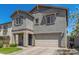 Charming two-story home with stone accents, a well-manicured lawn, and an attached two-car garage at 11526 E Shepperd Ave, Mesa, AZ 85212