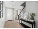 Inviting foyer with wood-look tile floors, neutral paint, and staircase leading to the upper level at 11526 E Shepperd Ave, Mesa, AZ 85212