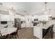 Open kitchen design with white cabinetry, a central island, stainless steel appliances, and stylish light fixtures at 11526 E Shepperd Ave, Mesa, AZ 85212