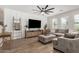 Inviting living room with a large sectional sofa, a modern ceiling fan, and tasteful decor at 11526 E Shepperd Ave, Mesa, AZ 85212