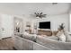 Spacious living room featuring a large sectional sofa and open access to other rooms at 11526 E Shepperd Ave, Mesa, AZ 85212