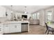 Open-concept living space with a modern kitchen flowing into a comfortable living room area with a large sofa at 11526 E Shepperd Ave, Mesa, AZ 85212