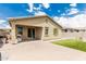 Backyard with artificial turf, a covered patio, and tan-colored exterior at 12357 W Whyman Ave, Avondale, AZ 85323