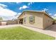 This charming backyard features a plush artificial lawn and covered outdoor kitchen space with built in BBQ grill at 12357 W Whyman Ave, Avondale, AZ 85323