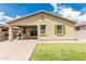 Backyard with a covered patio, artificial turf, and desert landscaping at 12357 W Whyman Ave, Avondale, AZ 85323