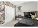 Bedroom with a black bed frame, carpet, and a window over a keyboard at 12357 W Whyman Ave, Avondale, AZ 85323
