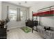 Bright bedroom featuring a bunk bed, wood-look tile flooring, and ample sunlight at 12357 W Whyman Ave, Avondale, AZ 85323