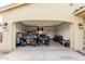 Garage showcasing two ATVs with an epoxy floor and overhead lighting at 12357 W Whyman Ave, Avondale, AZ 85323