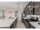 Bright kitchen with white countertops, stainless steel appliances, and grey wood look flooring at 12357 W Whyman Ave, Avondale, AZ 85323